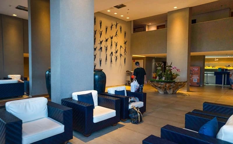 Lobby do resort com poltronas e decoração moderna.