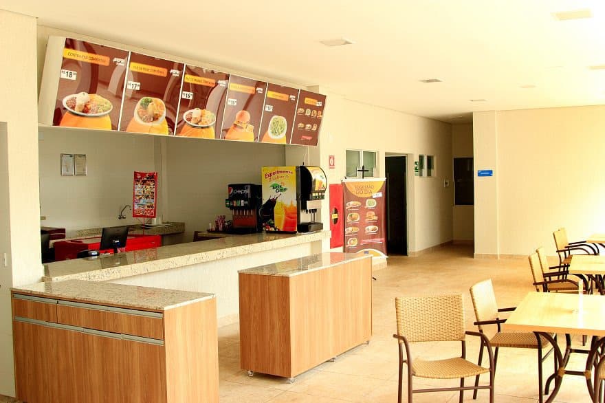 Cozinha compacta do apartamento com frigobar e micro-ondas.